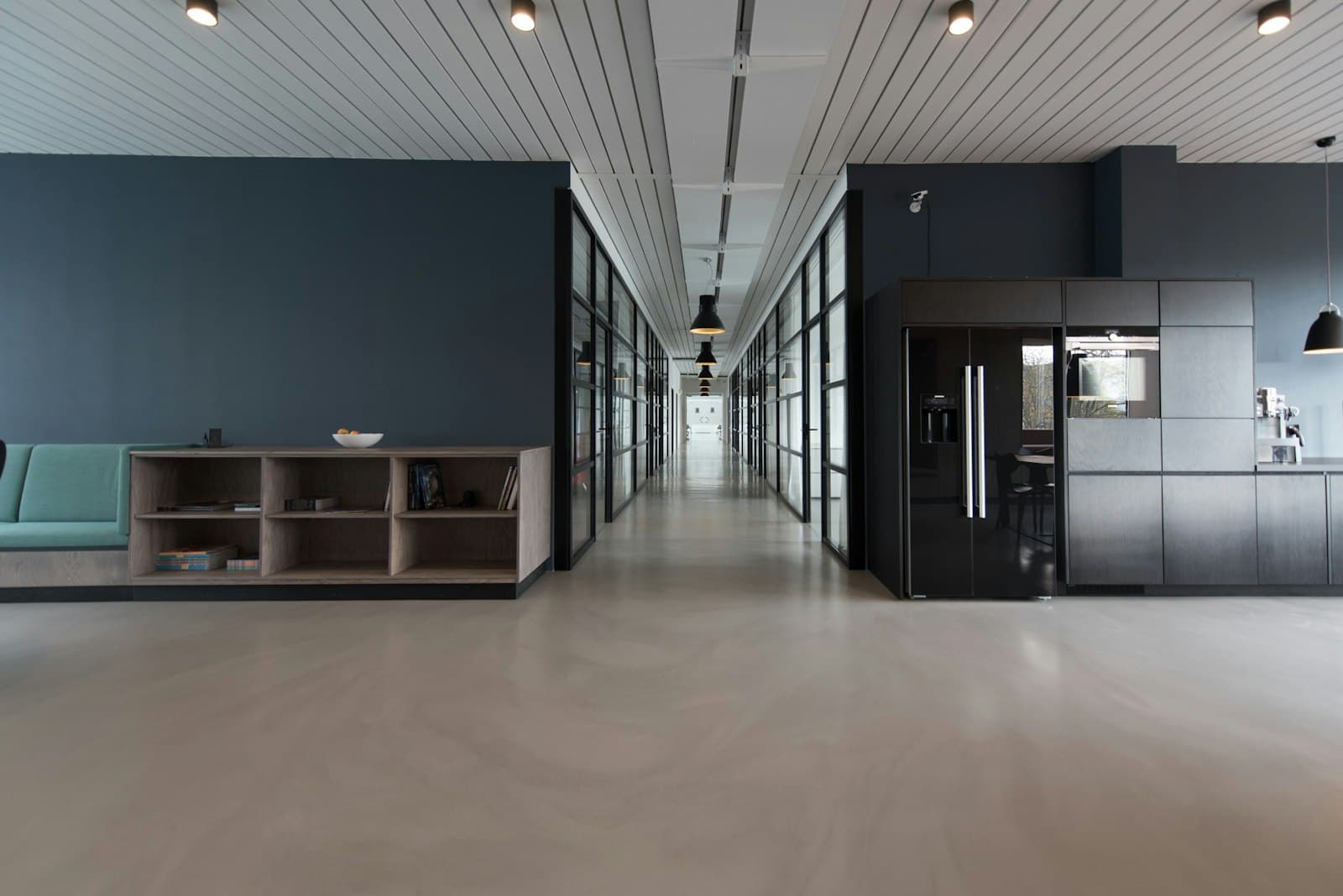 A quiet modern workspace with laptops left open after a meeting